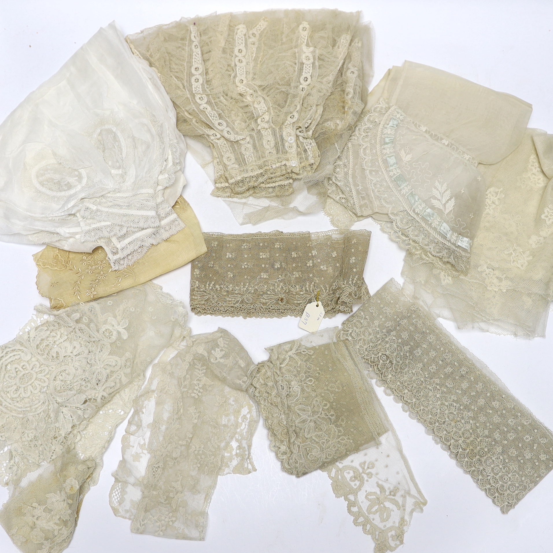 A collection of mostly 19th century French and English needle and bobbin lace trimmings, white worked sleeves, a black silk stole and black lace trimmings etc
